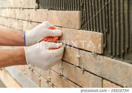 Installing the tiles on the wall. Installing the tiles on the wall. 28828784