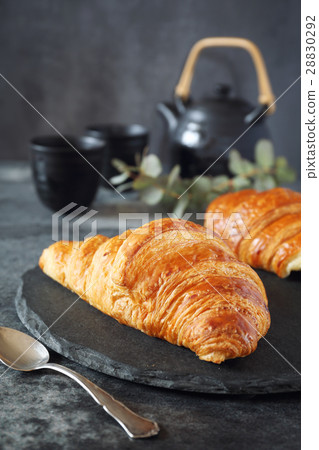 Two fresh croissants and teapot Two fresh croissants and teapot 28830292