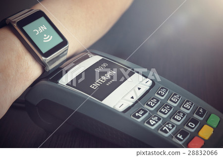 Man making payment through smartwatch via NFC Man making payment through smartwatch via NFC 28832066
