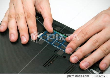 Man installing memory. Laptop RAM upgrade 28832379