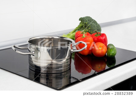 Pot and vegetables in modern kitchen Pot and vegetables in modern kitchen 28832389