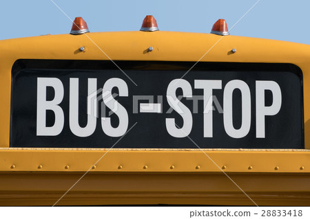 bus stop written on yellow school bus 28833418