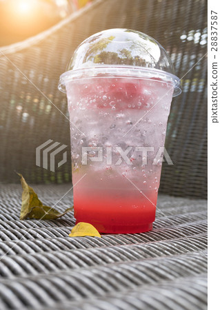 strawberry italian soda with ice on wickerwork 28837587