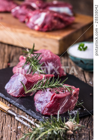 Beef.Raw beef tenderloin steak on a cutting board. 28838042