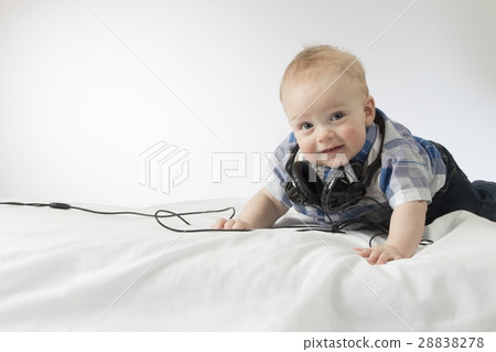 An infant child with headphones An infant child with headphones 28838278