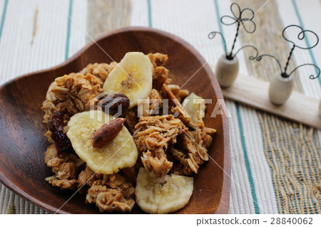 Granola and figurine in a heart-shaped wooden container Granola and figurine in a heart-shaped wooden container 28840062