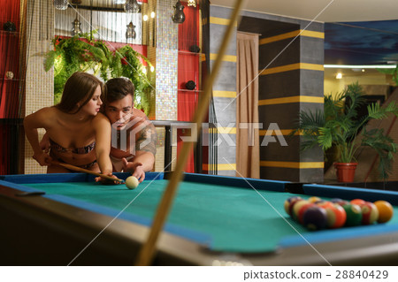 Young couple playing billiards in sauna Young couple playing billiards in sauna 28840429