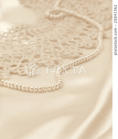 Smooth elegant golden silk or satin with pearls Smooth elegant golden silk or satin with pearls 28841362