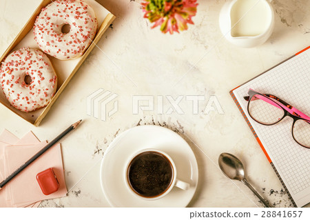 Notepad, donuts and coffee on white table. Notepad, donuts and coffee on white table. 28841657
