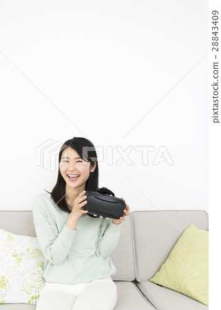 A young lady who enjoys VR at home 28843409