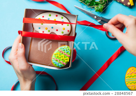 white caucasian female hands wrapping easter cake near things fo white caucasian female hands wrapping easter cake near things fo 28848567