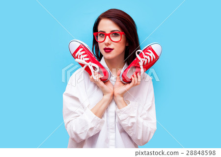 beautiful young woman with gumshoes standing in front of the won 28848598