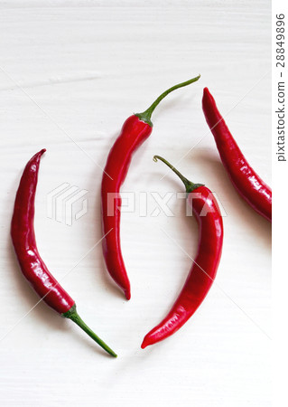 Red chili peppers on white Red chili peppers on white 28849896