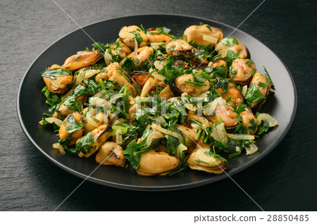 Mussels cooked with parsley, garlic and wine. 28850485