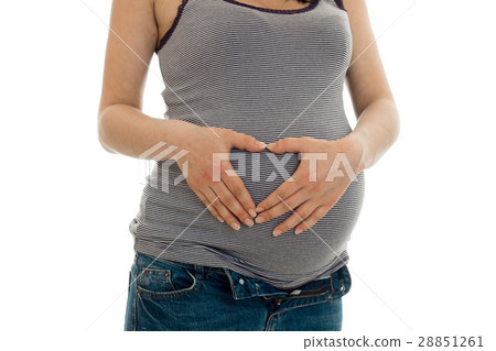the midsection of a young pregnant woman isolated the midsection of a young pregnant woman isolated 28851261