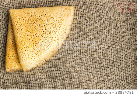 Thin Pancakes on a Burlap Background Top View Thin Pancakes on a Burlap Background Top View 28854781