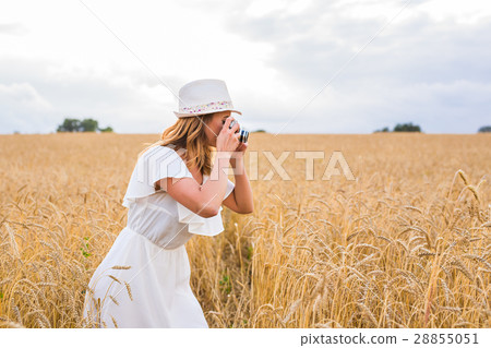 female photographer in the field with a camera 28855051