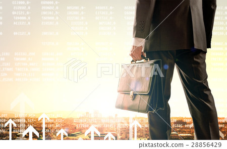 Businessman standing with back against city 28856429