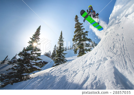 Flying snowboarder in the mountains Flying snowboarder in the mountains 28857035