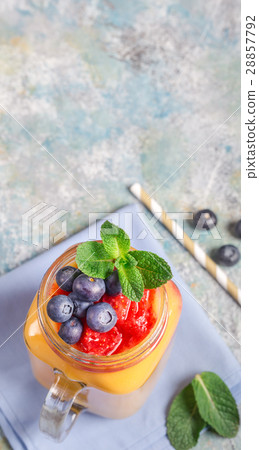 Mango drink and blueberries above Mango drink and blueberries above 28857792