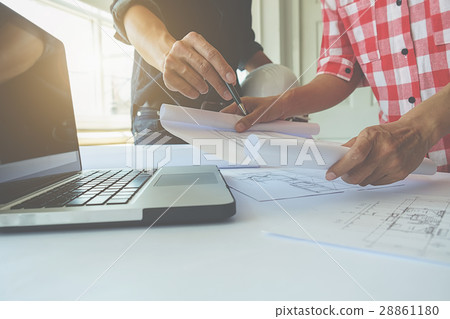 Hands of Engineer working on blueprint 28861180