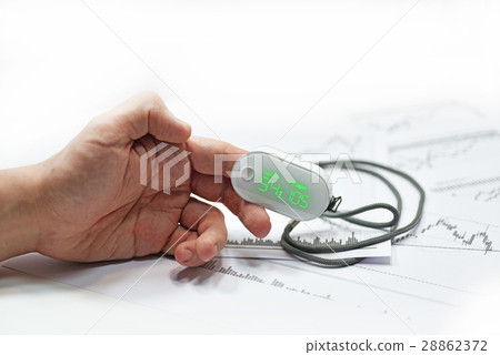 Blood oxygen meter on mans finger. 28862372