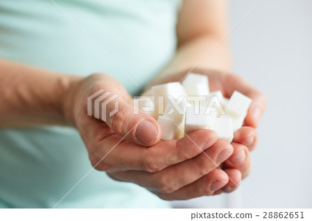 Male hands with cubes of white sugar Male hands with cubes of white sugar 28862651