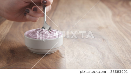 teen girl eating blueberry yogurt with spoon teen girl eating blueberry yogurt with spoon 28863901