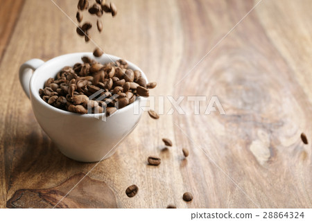 cappuccino cup with roasted coffee beans on wood cappuccino cup with roasted coffee beans on wood 28864324