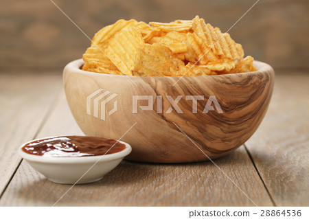 rippled potato chips with paprika and bbq sauce in rippled potato chips with paprika and bbq sauce in 28864536