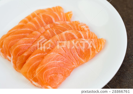 Sliced raw salmon on white plate 28866761