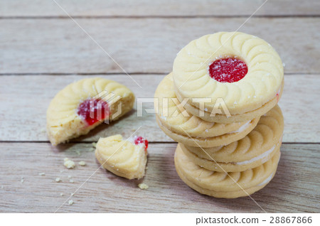 Sweet cookies with cream and jam on wood 28867866