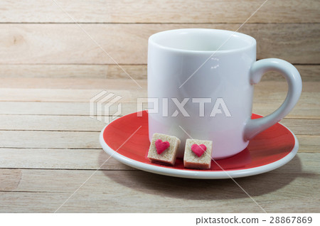 White coffee cup with brown sugar cubes on wood 28867869