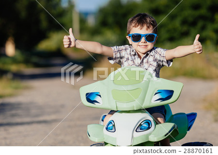Happy little boy playing on road at the day time. Happy little boy playing on road at the day time. 28870161