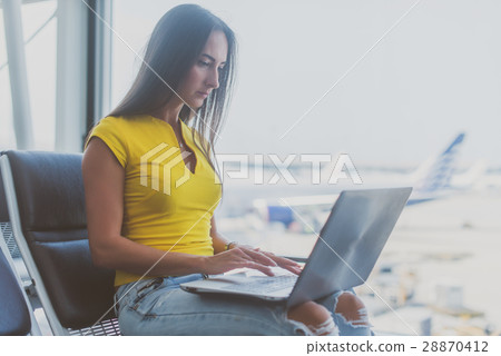 Young woman holding a laptop on lap typing 28870412