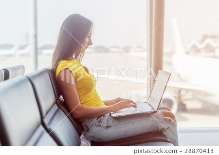 Cropped image of young woman holding a laptop on Cropped image of young woman holding a laptop on 28870413