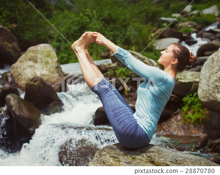 Woman doing Ashtanga Vinyasa Yoga asana outdoors 28870780