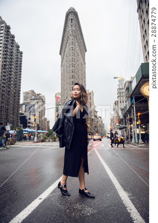 Fashionable asian woman cross New York City street Fashionable asian woman cross New York City street 28874779