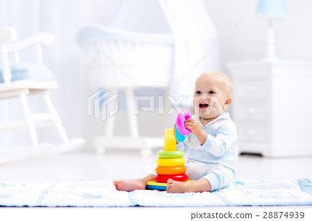 Baby playing with toy pyramid. Kids play Baby playing with toy pyramid. Kids play 28874939