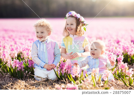 Kids playing in flower field 28875007
