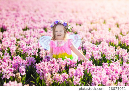 Little girl in fairy costume play in flower field 28875051