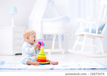 Baby playing with toy pyramid. Kids play 28875074