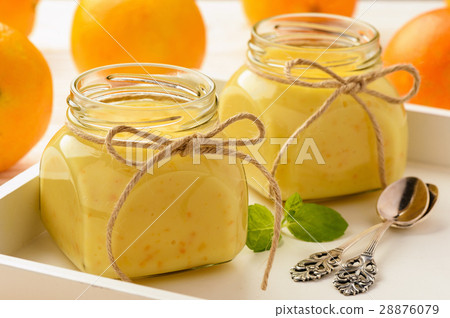 Orange curd (english citrus cream) in glass jars. 28876079