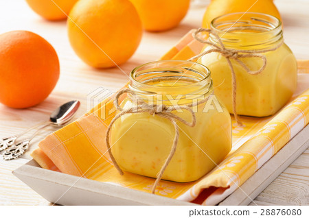 Orange curd (english citrus cream) in glass jars. 28876080