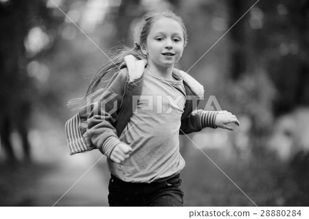 Girl 6-7 runs in the autumn park Girl 6-7 runs in the autumn park 28880284