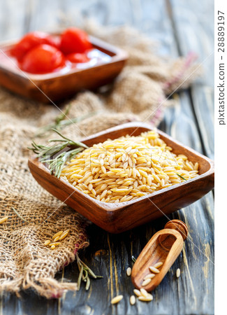 Bowls with Italian pasta orzo and tomato. Bowls with Italian pasta orzo and tomato. 28889197