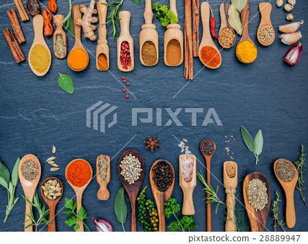Various of spices and herbs in wooden spoons. 28889947
