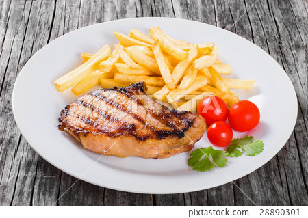 grilled pork chops on a white dish, close-up grilled pork chops on a white dish, close-up 28890301