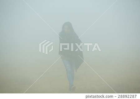 A woman going through the fog A woman going through the fog 28892287