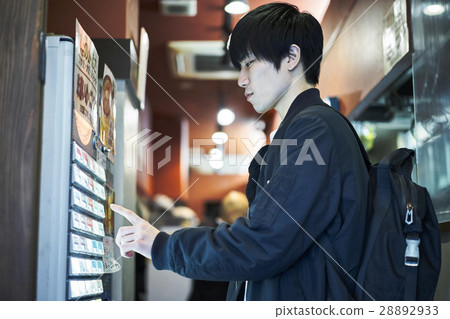 Men buying tickets 28892933